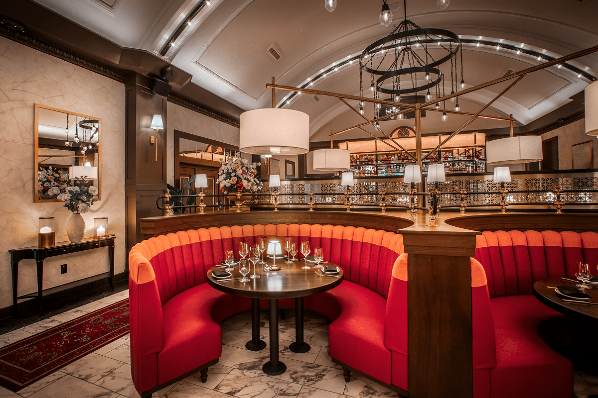 Elegant restaurant interior with red booth seating.