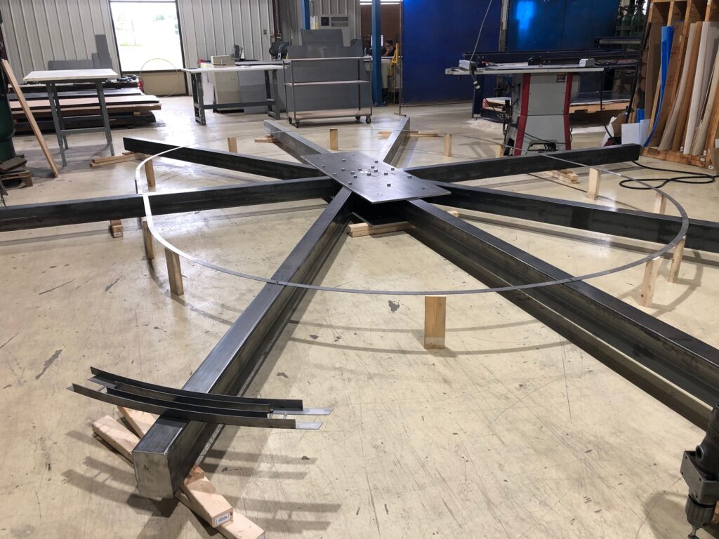 Large metal structure on workshop floor.